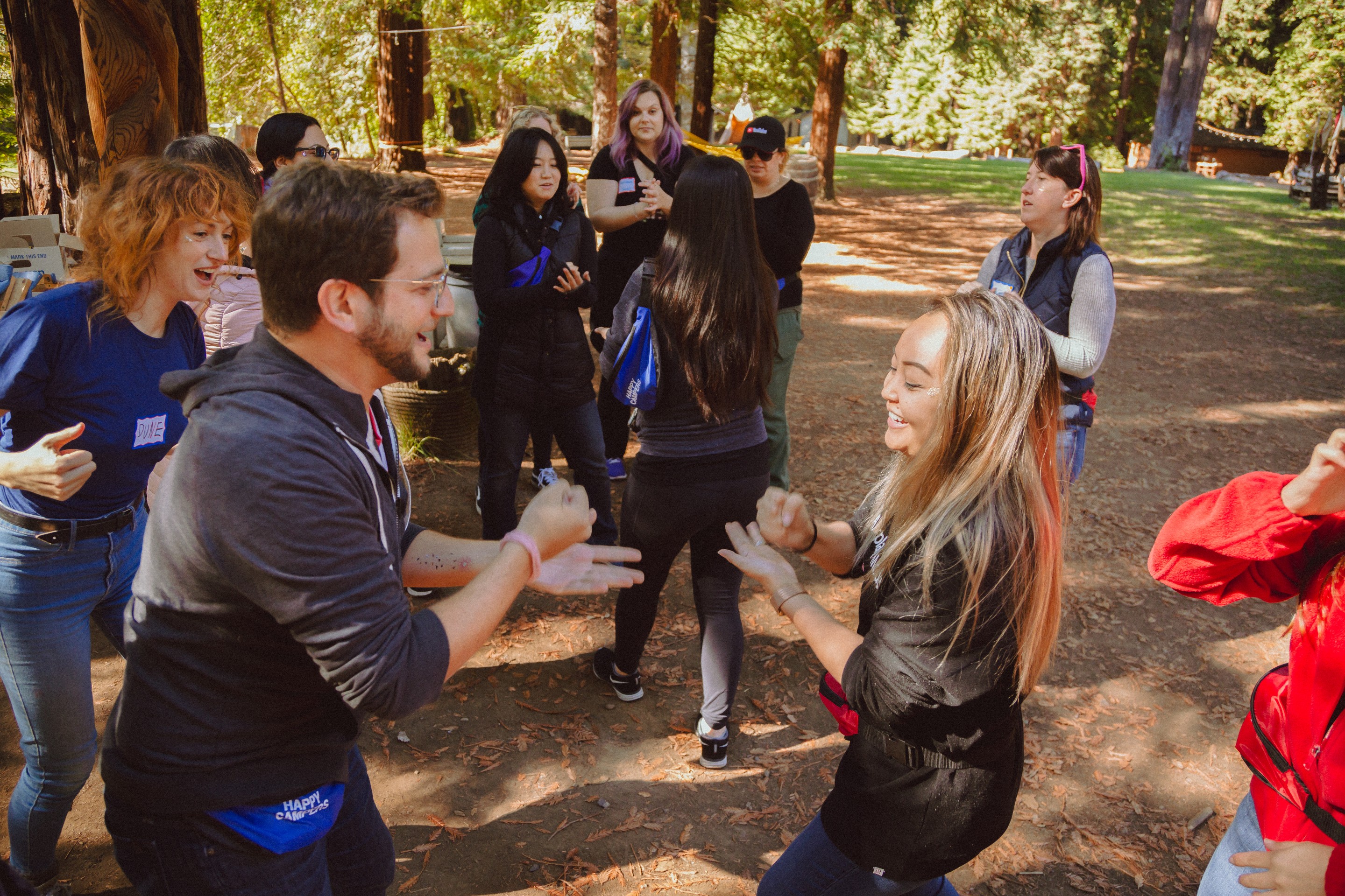 Team gathered together in the woods at summer camp